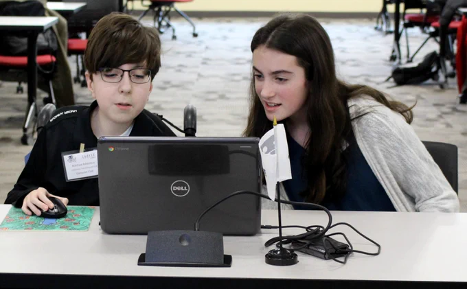 Two students participating in the Cyber Robotics Coding Competition