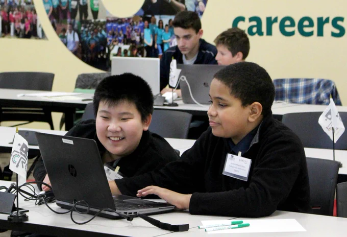 Two students participate in the Cyber Robotics Coding Competition