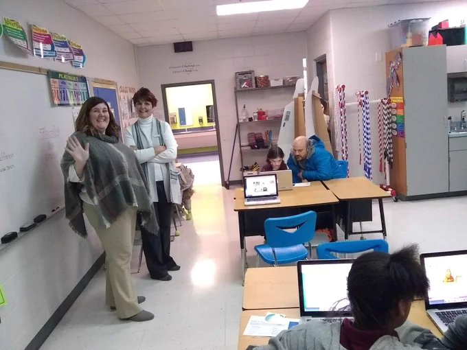 2 teachers helping kids code