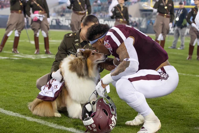 Trayveon Williams bends down to talk to Reveille