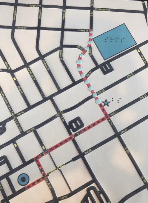 A tactile route from a school to bus station using swell paper. School and bus stop have braille labeling.