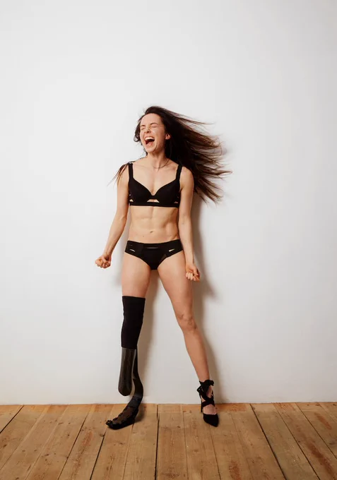Stef wearing her running blade, a high heel, black lingerie, fists clenched, screaming in frustration