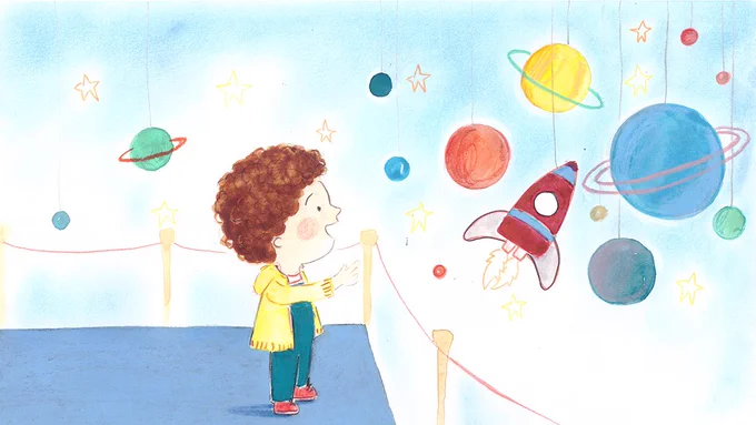 A young boy staring excitedly at models of planets and a rocket in a museum