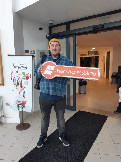 person holding a sign saying #hack access sligo