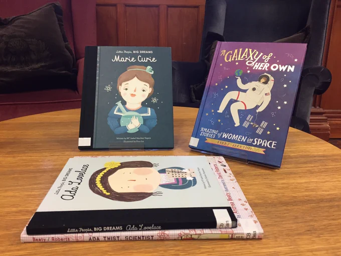 4 books on a table. They are big and brightly illustrated. One is ‘Marie Curie’ and shows Marie on the cover. Another is ‘A Galaxy of Her Own’ which has amazing stories of women in space inside and on the cover has a woman astronaut holding the earth in the palm of her hand. The two other books are about ‘Ada Lovelace’ and ‘Ada Twist, scientist’.