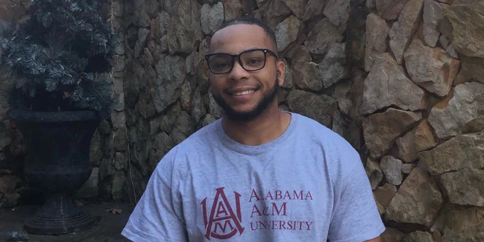 Kyle Harris smiles while wearing an Alabama A&M t-shirt