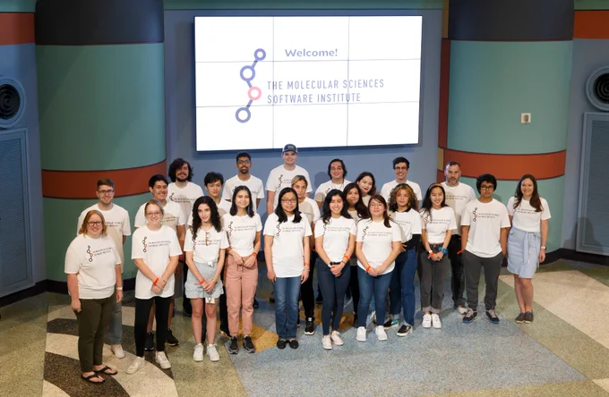 Students and instructors in front of MolSSI sign.
