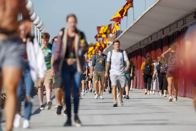 Students walk across the Washington Avenue Bridge.