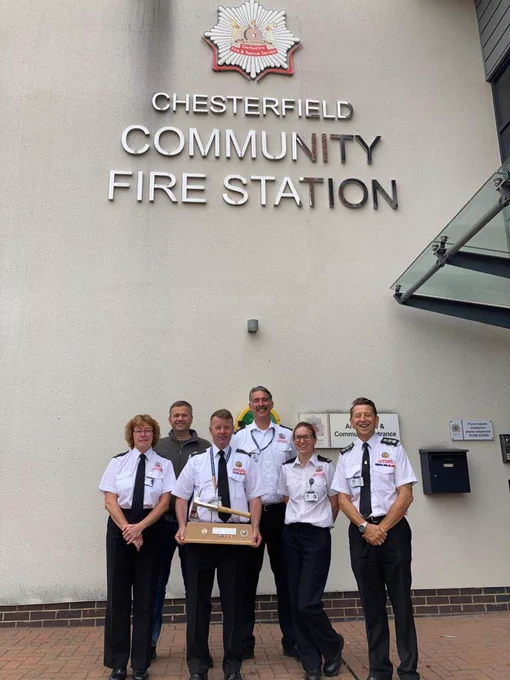 Fire Officers presenting axe to retiring officer.