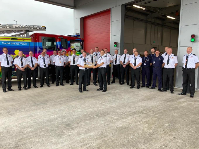 Fire Officers presenting axe to retiring officer.
