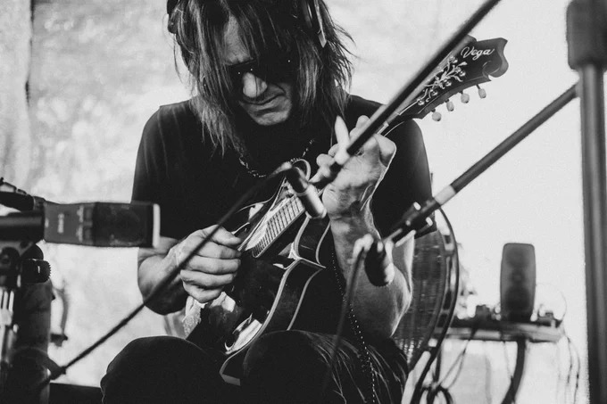 3 black and white images of Robin Finck recording in Joshua Tree.