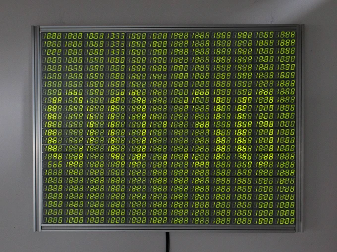 many individual 18:88 clock LED displays are combined into one very large display, showing a bleary view of a countdown timer