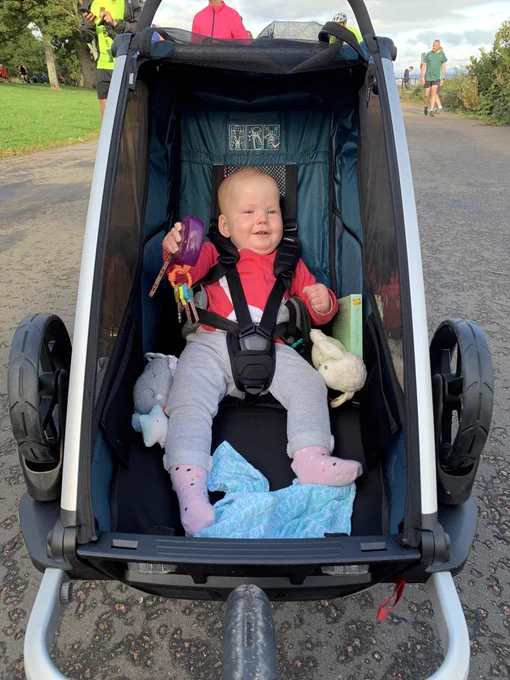A toddler in a running buggy