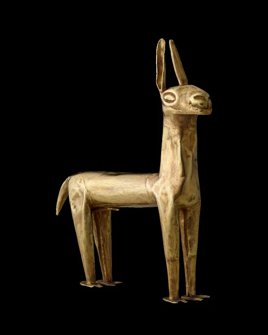 A small gold figure of a llama facing to the right against a black background.