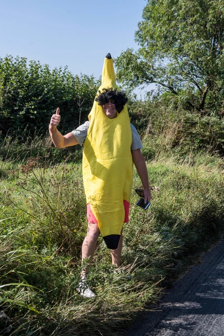Fan smiling, giving the camera a thumbs up whilst wearing a banana costume
