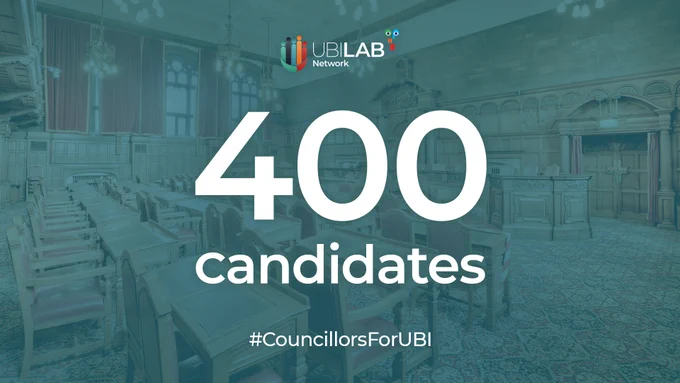 A graphic with a background image of seats in an empty council chamber with a blue tint.

Overlaid are the words "400 Candidates" in white.

At the top is the UBI Lab Network logo.

At the bottom of the image is the hashtag #CouncillorsForUBI