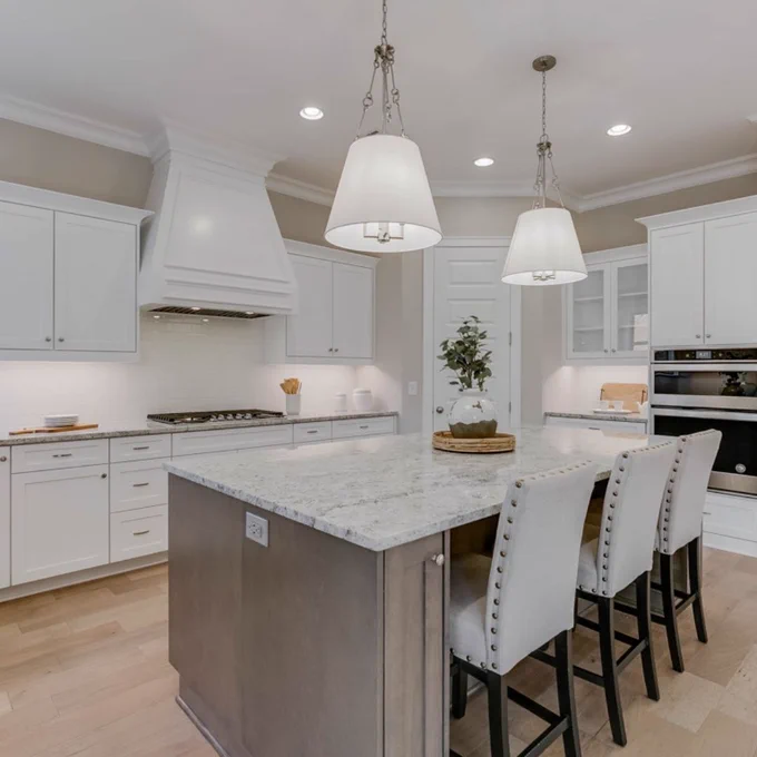 gourmet kitchen with oversized island, pendant lighting, gray/brown mixed with white color scheme