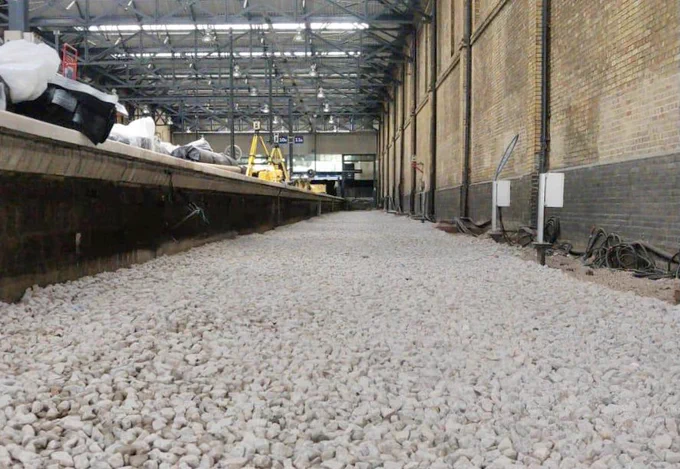 Newly laid ballast on an empty platform eleven at London Kings Cross Station.
