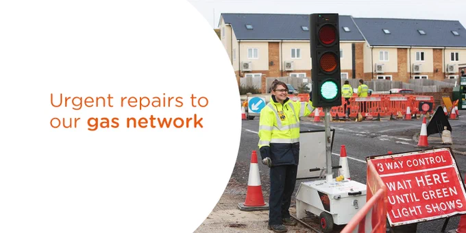 An SGN engineer operating temporary traffic lights.