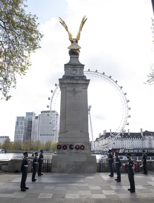 Image shows the personnel in front of the RAF memorial with the London Eye in the background.