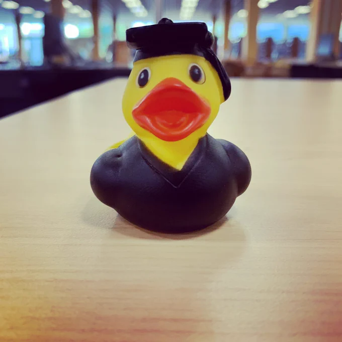 Graduation rubber duck on a table with the 3rd floor in the background