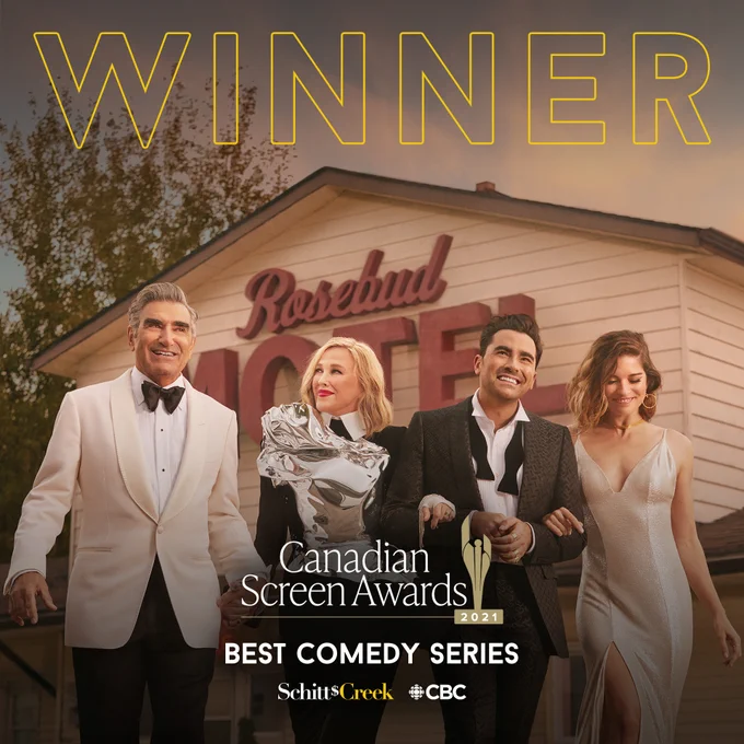 The main cast of Schitt’s Creek — Eugene Levy, Catherine O’Hara, Dan Levy and Annie Murphy — outside the iconic Rosebud Motel as their respective characters: Johnny, Moira, David and Alexis Rose. They’re dressed to the nines, holding hands and looking very happy. Above them, the word “winner”. Below, the Canadian Screen Awards logo and the name of the award: Best Comedy Series. 