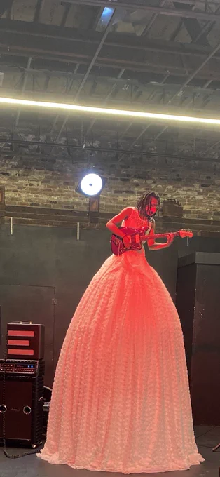Performance artist playing the guitar 15 feet in the air
