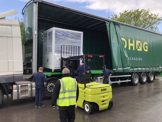Machine being loaded on to a customers lorry for transport to site.