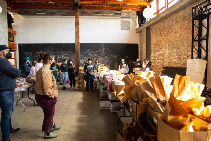 A crew of trusty volunteers listen to instructions on packing day— photo by @daybydavon!