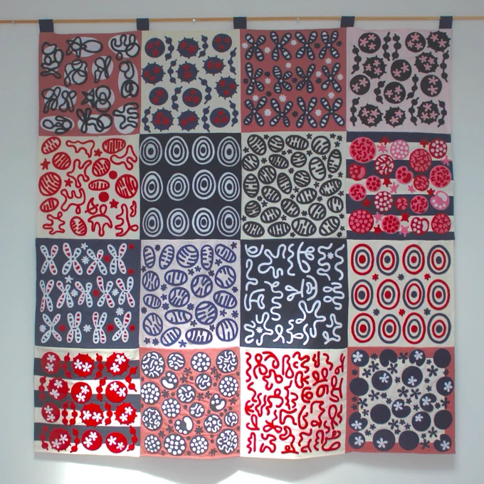 A graphic wall hanging in red, white, grey, and black