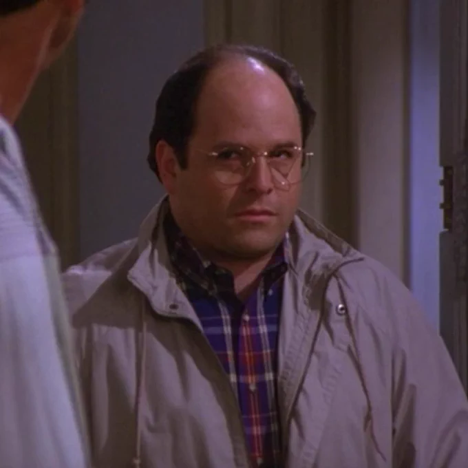 A still image from Seinfeld in which George Costanza is staring at Kramer, who is just off-camera, judgmentally.