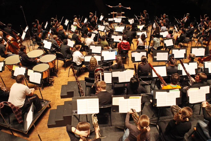 The Portland Youth Philharmonic rehearses, seen from behind