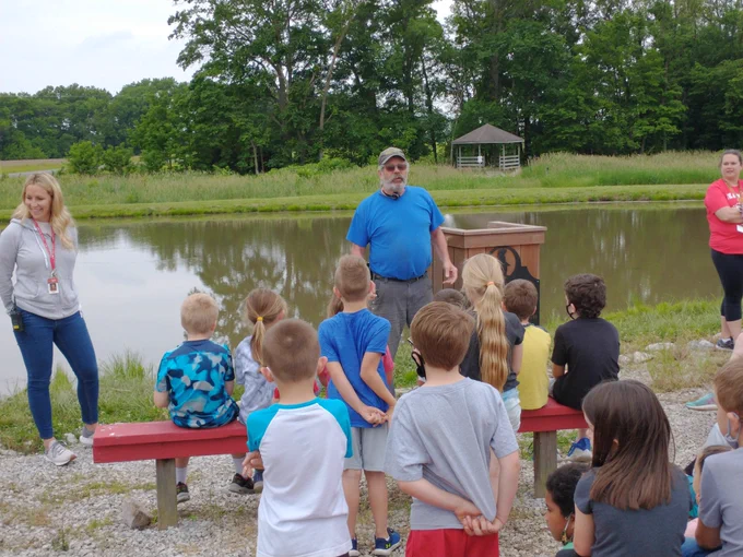 Ed McMillen Of MnN Fish explaining to the kids about the process of stocking the pond, and what fish would be stocked.