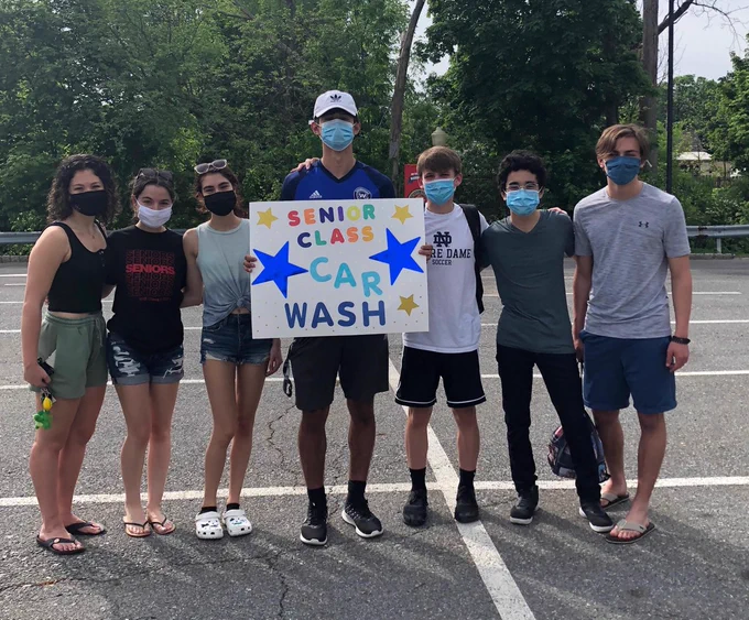 Photo of seven students from the Washingtonville High School senior class, holding a sign that reads: Senior Class Car Wash.