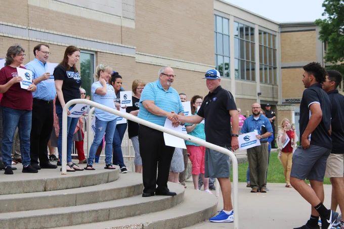 Head Coach, Travis Lallemand shakes hand with Crowder College President, Glenn Coltharp.