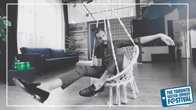 A photo of Darrell Faria sitting in a chair made of rope that hangs from the ceiling, in mid swing. The photo is stylized for that only the colours blue and green pop. There is a thin white border and in the bottom right corner is the Toronto Sketch Comedy Festival logo.