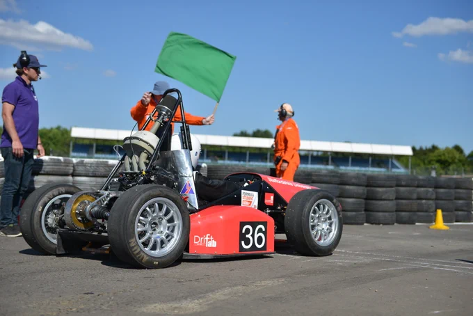 Staffordshire Uni Racing prepare to start the Sprint event at FS2019 at Silverstone, with a Marshall raising a green starter flag