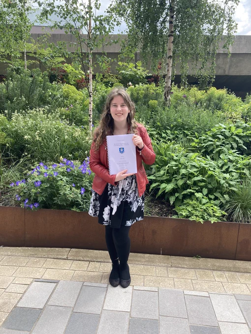 Jen stood holding dissertation