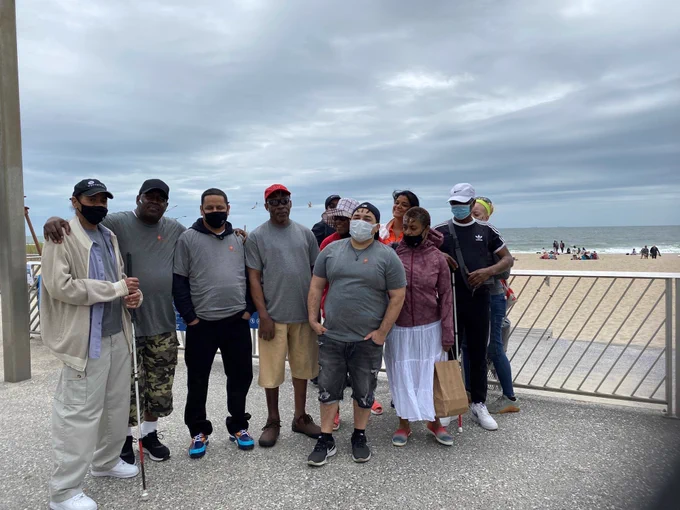 Image of Alphapointe team members gathered for a group photo at Rockaway Beach. 