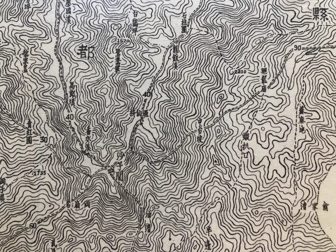 Detail of a tan map covered in contour lines in Chinese