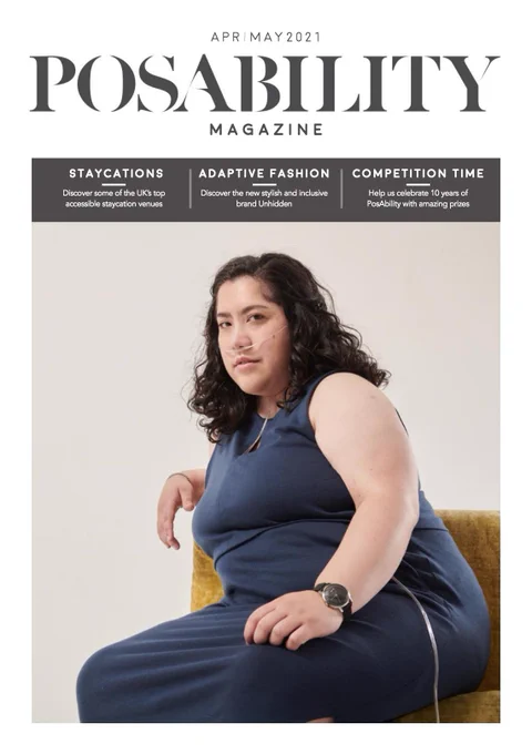 Image shows the cover of PosAbility Magazine with an image of a woman wearing a navy blue dress with a discreet oxygen tube coming out of it. She is sitting on a gold coloured sofa and the background is a pale grey. The cover trails read: Staycations - Discover some of the UK's top accessible staycations. Adaptive Fashion - Discover the new stylish and inclusive brand Unhidden. Competition Time - Help us celebrate 10 years of PosAbility with amazing prizes