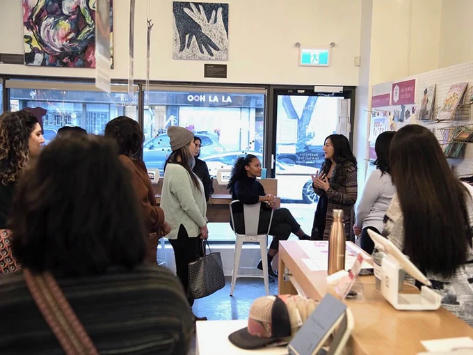 A crowd of diverse people at an event in the Humainologie Gallery pre-pandemic 