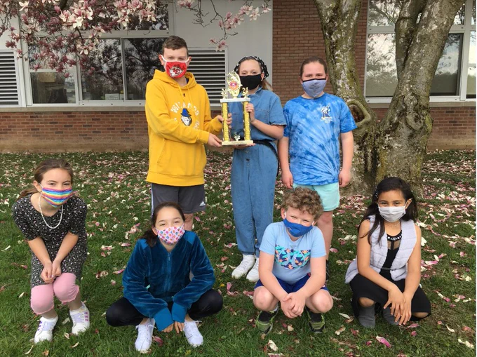 Washingtonville Odyssey of the Mind students pose for a photo with their trophy. 