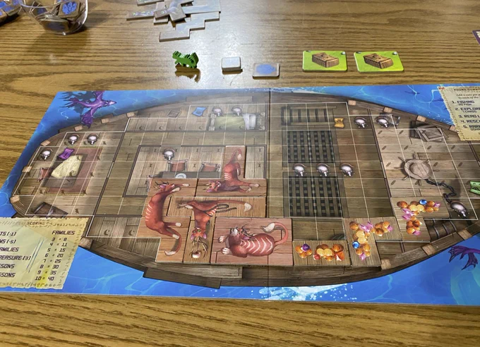 A player board for the Isle of Cats game, shaped like a boat