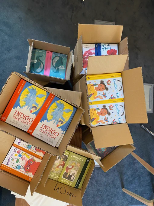 A photo taken from above of open boxes of books