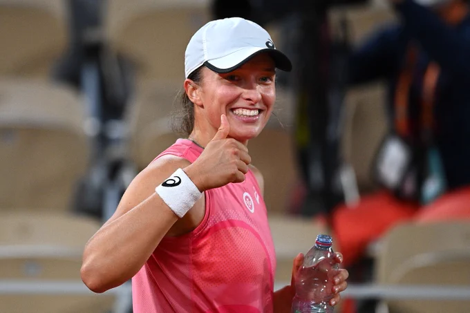 Poland's Iga Swiatek celebrates after winning against Ukraine's Marta Kostyuk at the end of their women's singles fourth round night session tennis match on Day 9 of The Roland Garros 2021 French Open tennis tournament in Paris on June 7, 2021. 