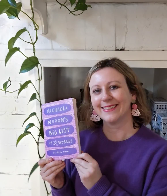 Liz holding Michaela Mason's Big List of 23 worries.
