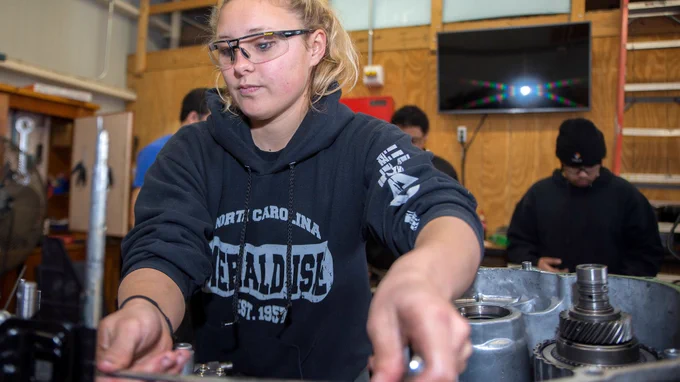 NOVANighthawks student is wearing safety glasses and working on a hands on assignment/project in class.