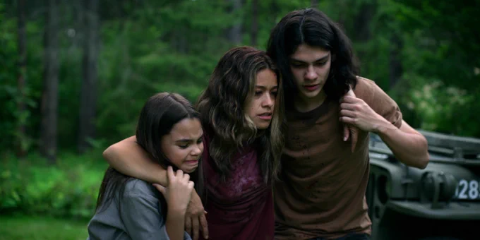 Gina Rodriguez's character in "Awake" being carried by both of her kids in the film.