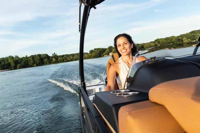 Woman driving a Harris Pontoon Boat